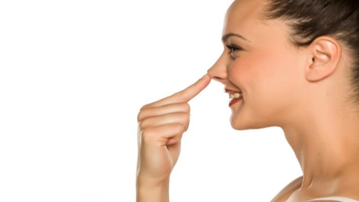 אישה מחוייכת לאחר פיסול אף באמצעות הזרקות חומצה היאלורונית