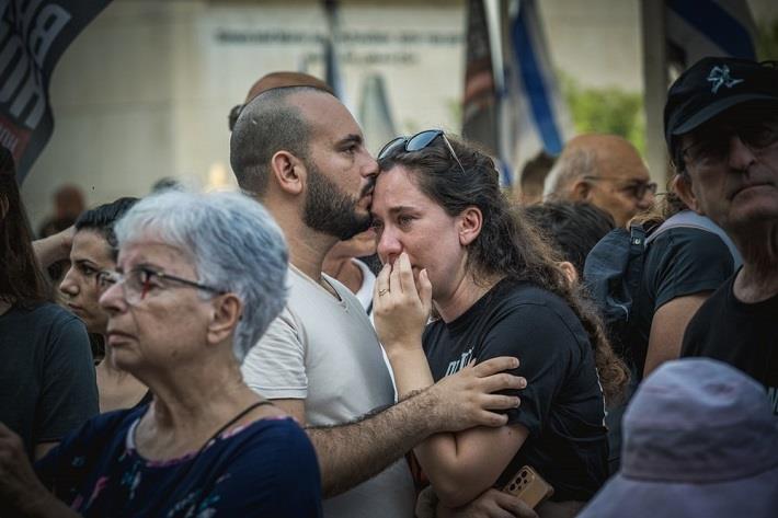 אישה וגבר בטראומה בתוך קהל אחרי השביעי באוקטובר